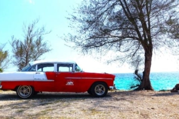 Classic American car on the shores of the Bay of Pigs, Cuba.
